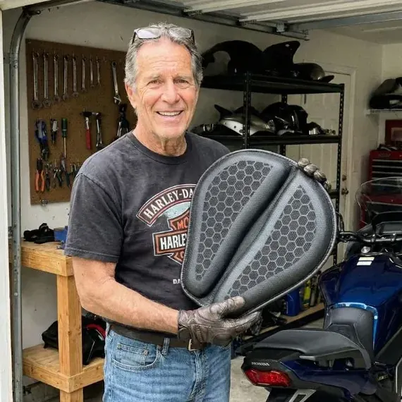 Nick J. holding his SelleZen cushion in his garage